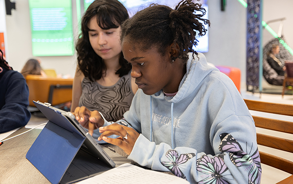 Young Writers Institute camper typing on a tablet