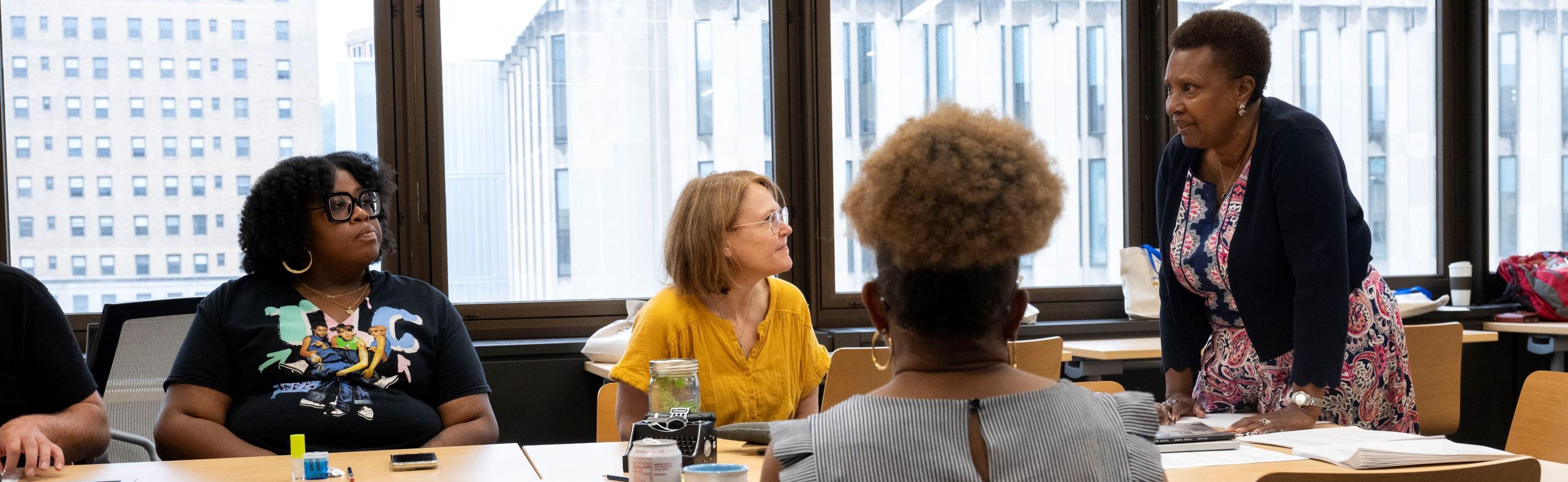 Educators seated at table for writing workshop